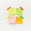 Four colorful sticky notes on white backdrop with vibrant tape. Perfect for office or organizational themes.
